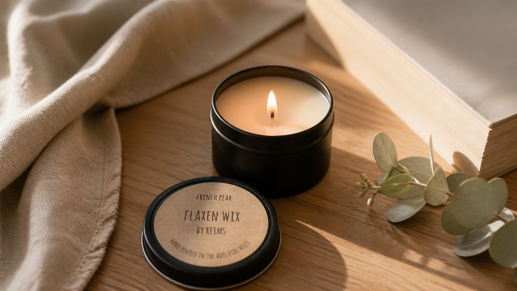 A lit Flaxen Wix candle in a calm home setting